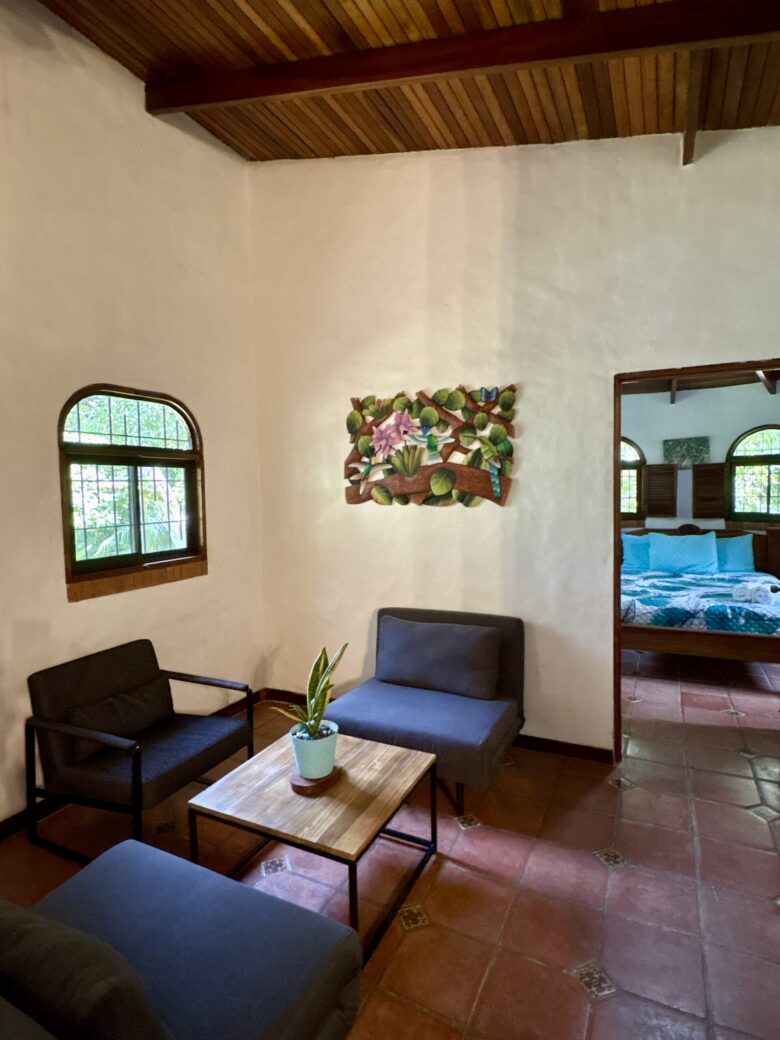 Cozy villa living room overlooking rainforest scenery