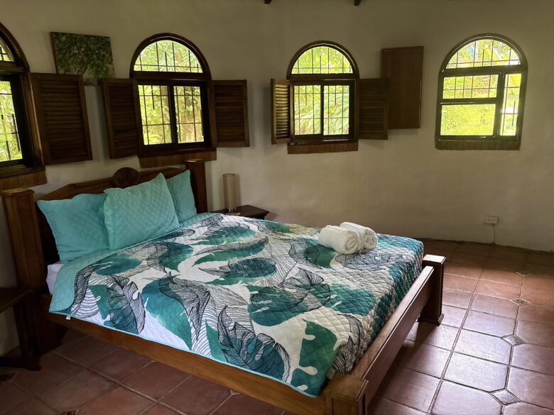 Villa bedroom with rainforest view and soft lighting