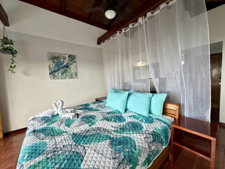 Premium ocean view room with elegant bedding, natural textures, and tropical-inspired décor at Planeta Sano.