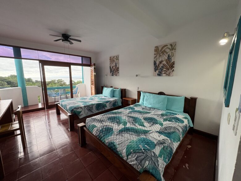 Premium ocean view room interior with warm wood accents and Pacific views at Planeta Sano Hotel.