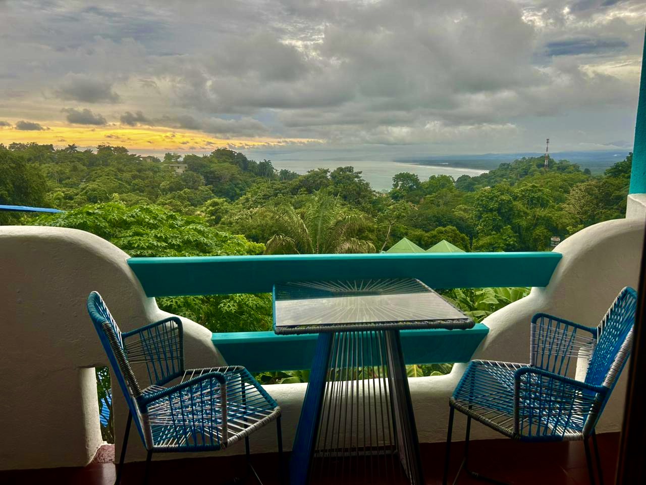 Premium ocean view room showcasing spacious layout and lush rainforest surroundings at Planeta Sano Hotel.