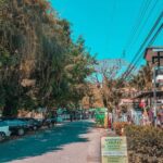 Vibrant town of Manuel Antonio with shops, restaurants, and lush rainforest surroundings.