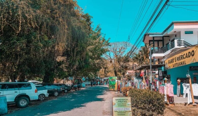 Vibrant town of Manuel Antonio with shops, restaurants, and lush rainforest surroundings.