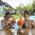 Two women enjoying cocktails at the bar in Hotel Planeta Sano