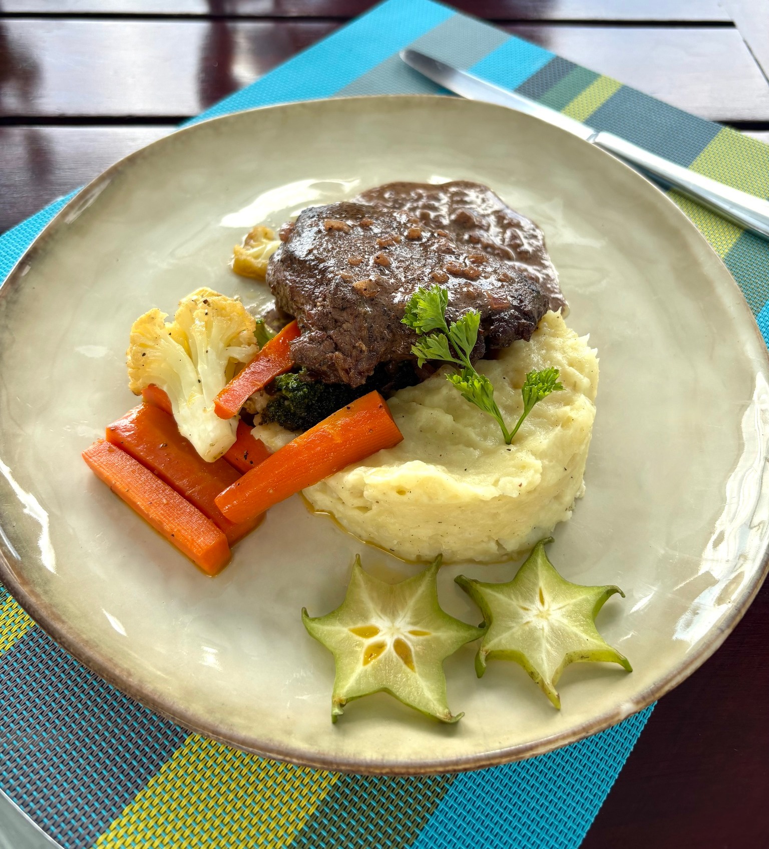 Juicy grilled steak served with fresh sides at Planeta Sano Restaurant in Manuel Antonio.