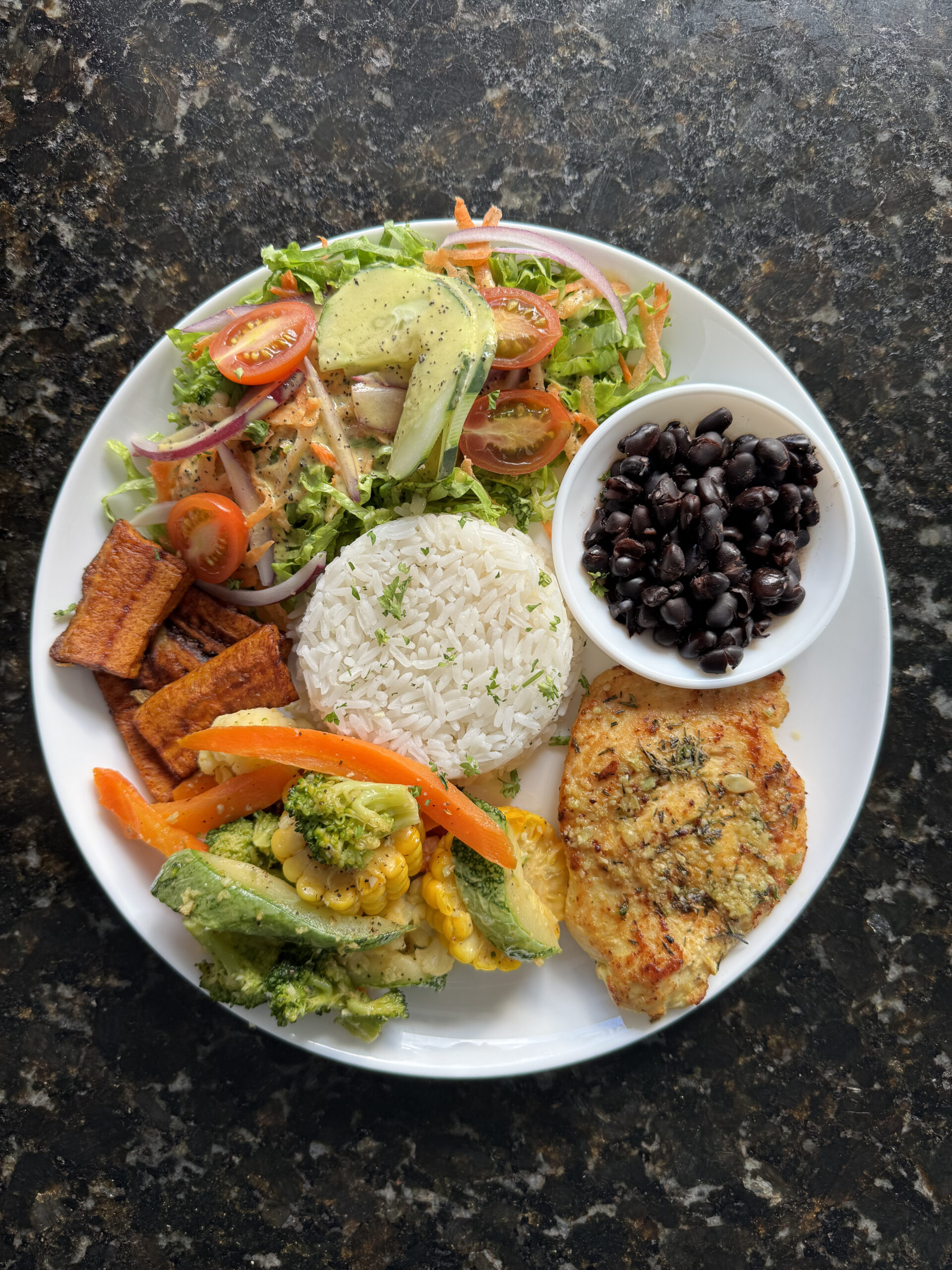 Traditional Costa Rican casado served with rice, beans, salad, and plantains at Planeta Sano.